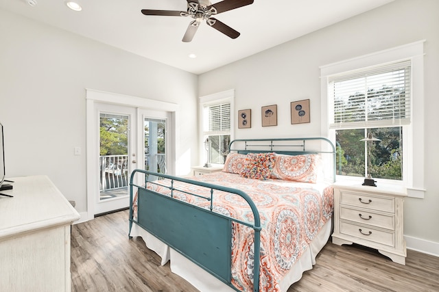 bedroom featuring multiple windows, ceiling fan, and light wood-type flooring