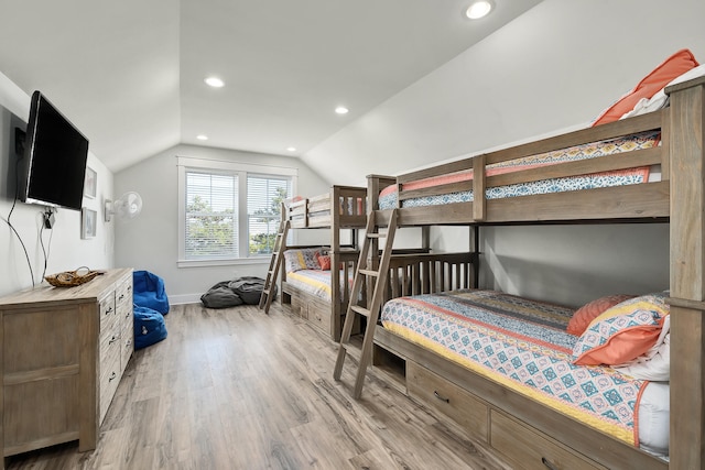 bedroom with lofted ceiling and light wood-type flooring