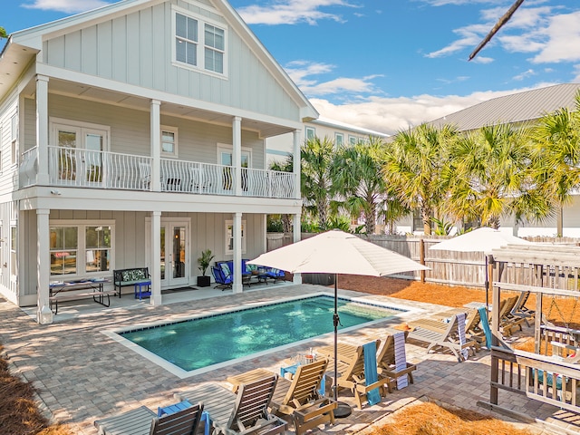 view of pool featuring french doors, an outdoor hangout area, and a patio