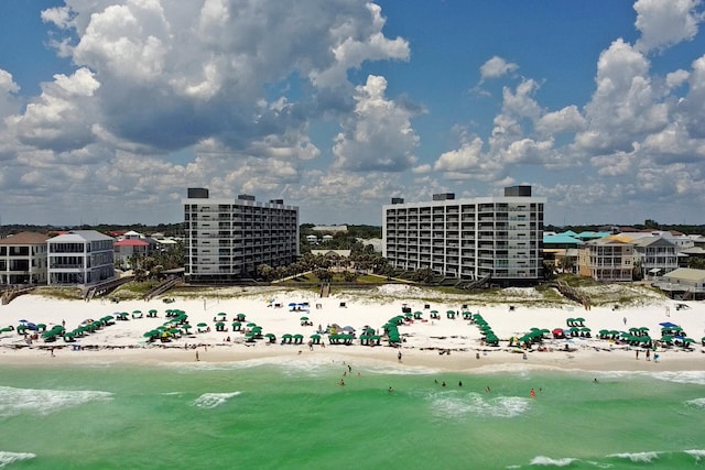 aerial view with a water view and a beach view