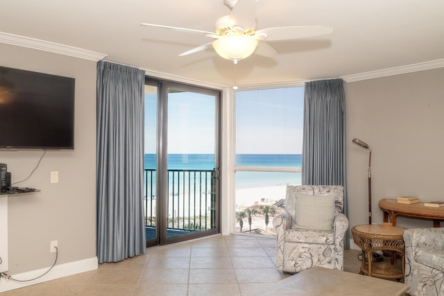 living area with light tile patterned floors, ceiling fan, a water view, and crown molding