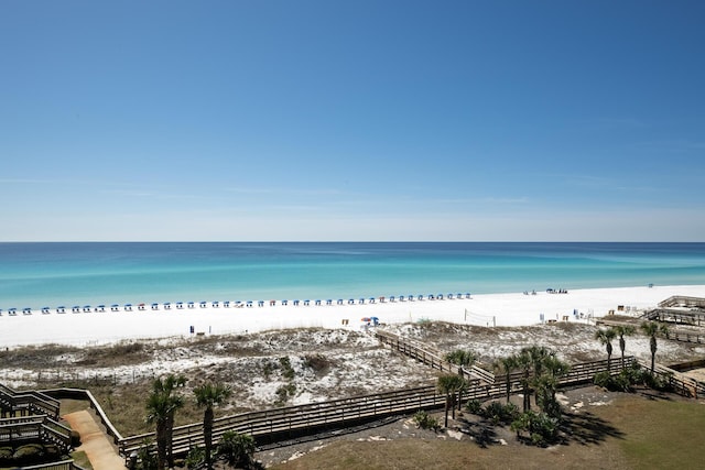 view of water feature with a view of the beach and fence