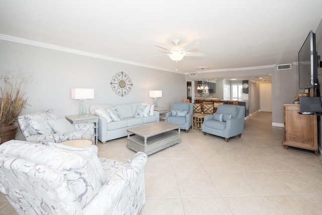 living room featuring ornamental molding, a ceiling fan, visible vents, and light tile patterned floors