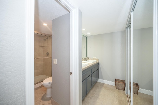 full bathroom with baseboards, toilet, tile patterned floors, vanity, and a shower stall