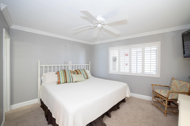 carpeted bedroom with a ceiling fan, crown molding, and baseboards