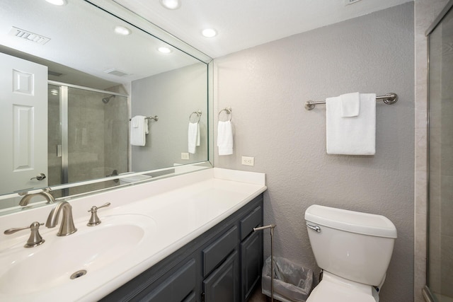 bathroom featuring recessed lighting, visible vents, toilet, a shower stall, and vanity