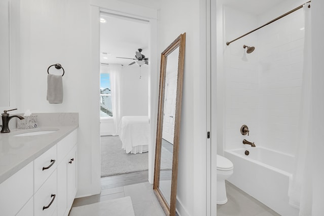 full bathroom with ceiling fan, shower / washtub combination, tile floors, toilet, and large vanity