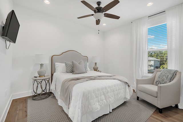 bedroom with ceiling fan and hardwood / wood-style floors