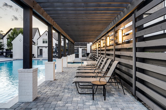 view of terrace with a community pool and a pergola