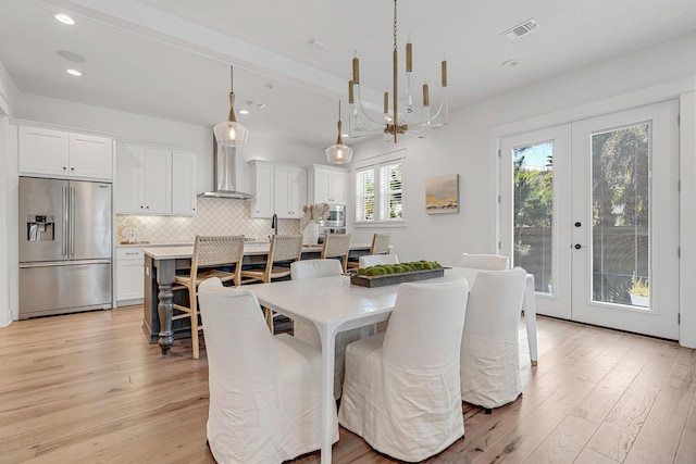 dining area featuring light hardwood / wood-style floors and french doors