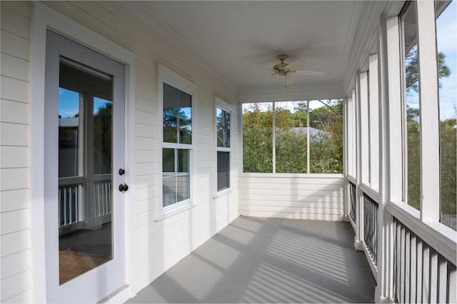 unfurnished sunroom featuring ceiling fan