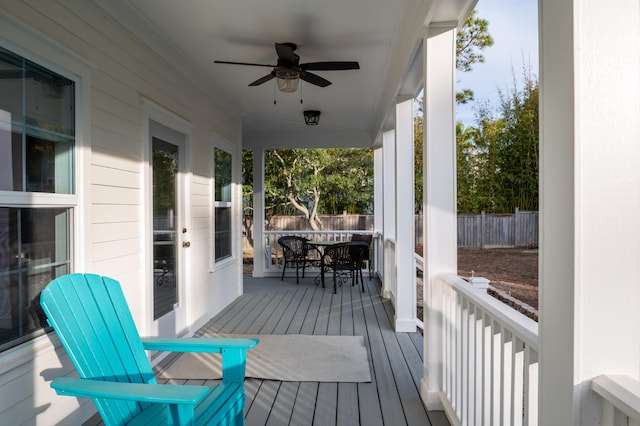 wooden deck featuring ceiling fan