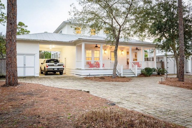 view of front of property with covered porch, ceiling fan, and a storage unit