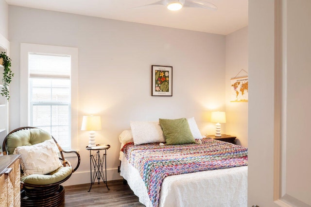 bedroom with ceiling fan and dark hardwood / wood-style floors