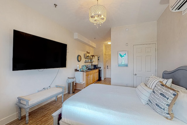 bedroom featuring a chandelier, light hardwood / wood-style flooring, and a wall mounted AC