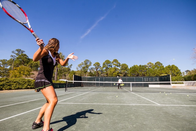 view of sport court featuring fence