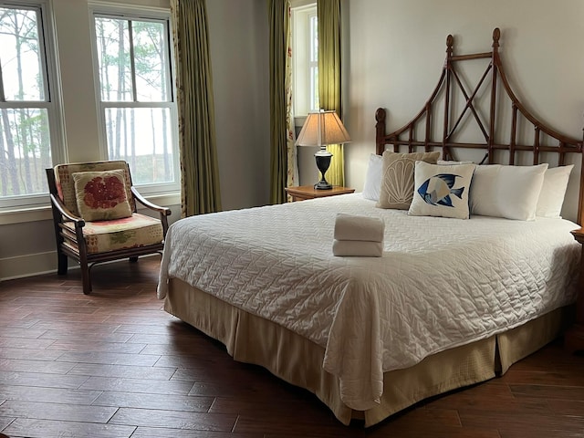 bedroom featuring wood finished floors and baseboards