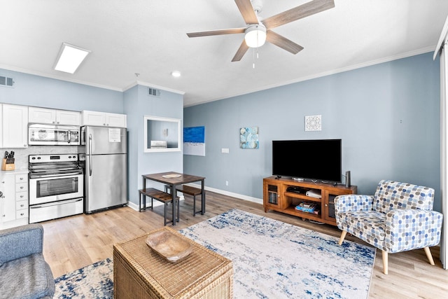 living room with light hardwood / wood-style flooring, ceiling fan, and ornamental molding