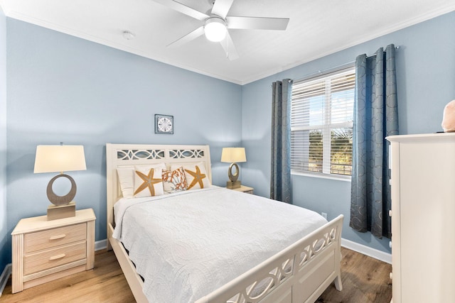 bedroom with wood-type flooring, ceiling fan, and crown molding