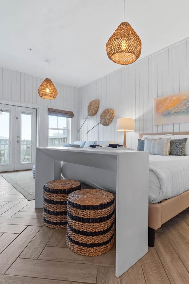 bedroom with french doors and light parquet floors