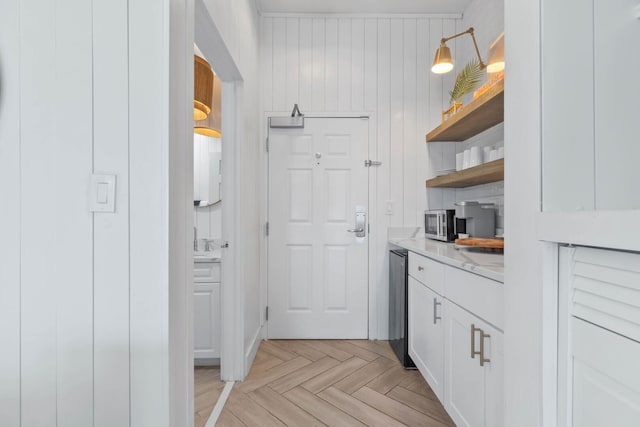 interior space featuring white cabinets and light parquet floors