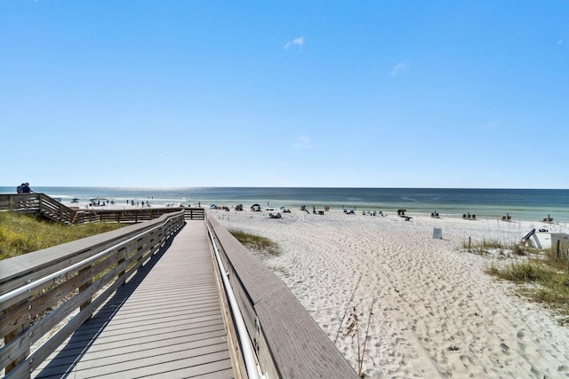 exterior space featuring a water view and a beach view