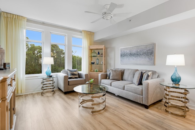 living room featuring ceiling fan, a healthy amount of sunlight, and light wood-type flooring