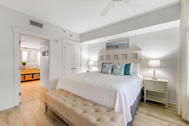 bedroom with a closet, ceiling fan, and light hardwood / wood-style floors