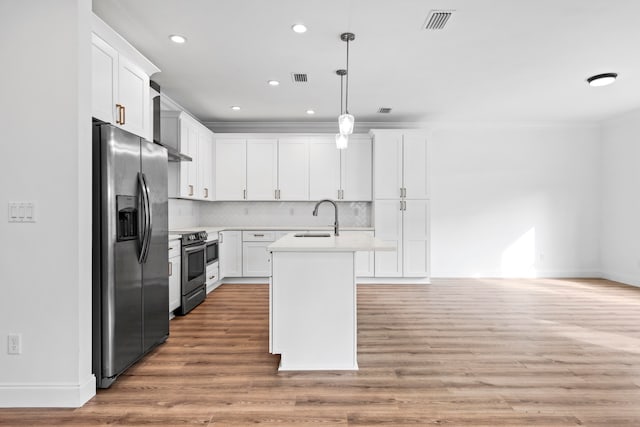 kitchen featuring light hardwood / wood-style flooring, pendant lighting, stainless steel appliances, and white cabinetry