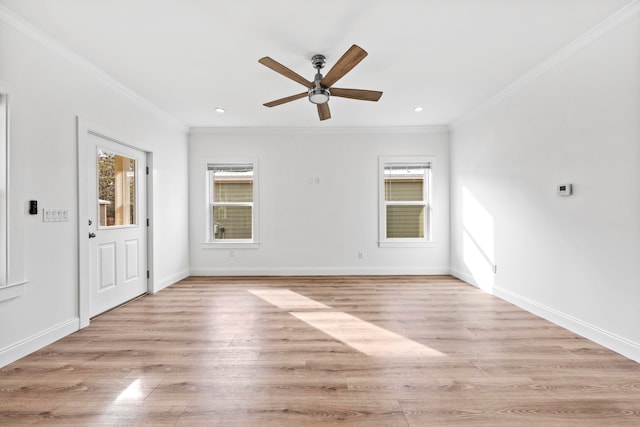 spare room featuring crown molding, light hardwood / wood-style flooring, and ceiling fan