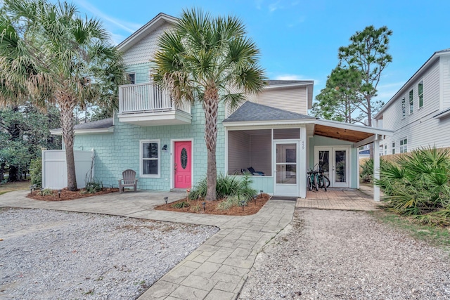 view of front of property with french doors and a balcony