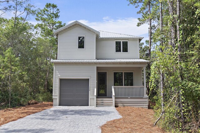 112 S Magnolia Beach Way, Santa Rosa Beach, FL 32459 - view of front facade featuring a porch, metal roof, a garage, and decorative driveway