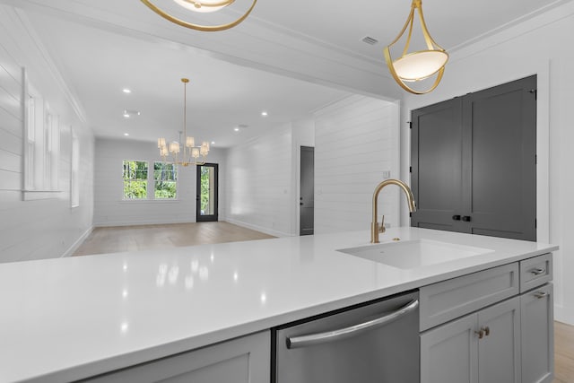 kitchen with dishwasher, light hardwood / wood-style floors, hanging light fixtures, and sink