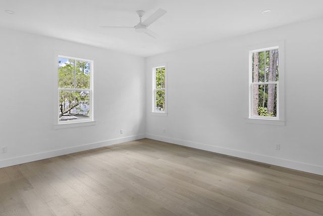 spare room featuring ceiling fan and light hardwood / wood-style flooring