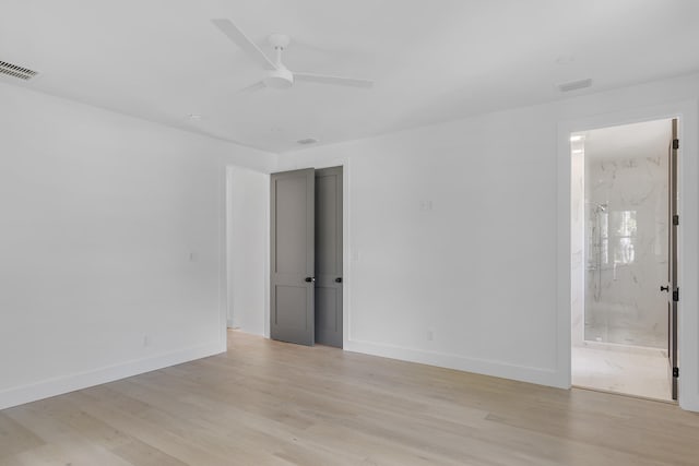 spare room featuring light wood-type flooring and ceiling fan