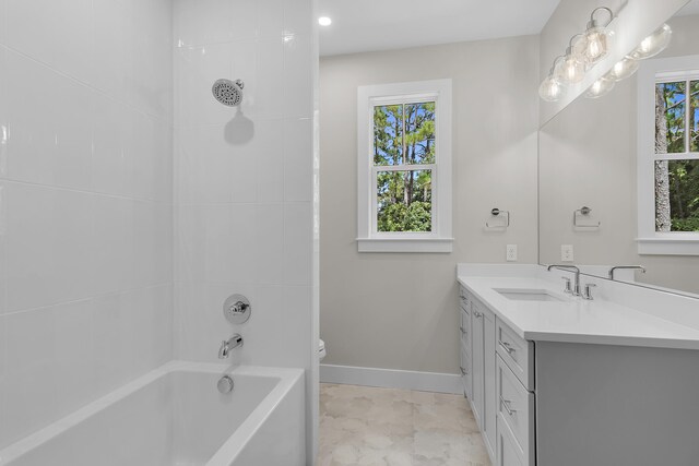 full bathroom with vanity, toilet, and tiled shower / bath