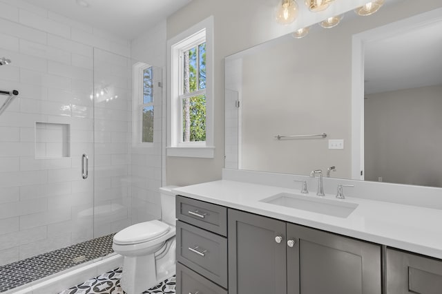 bathroom featuring tile patterned floors, a shower with shower door, vanity, and toilet