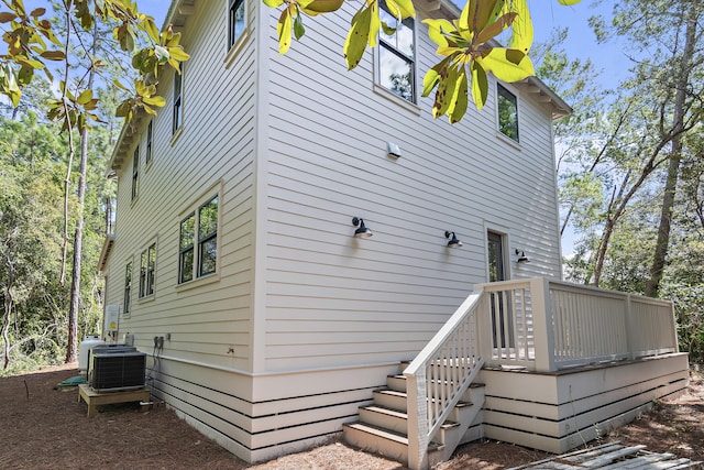 view of home's exterior featuring a wooden deck and central AC