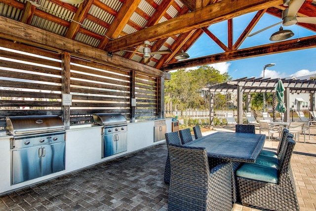 view of terrace featuring exterior kitchen, ceiling fan, area for grilling, and a gazebo