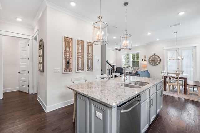 kitchen with a center island with sink, dishwasher, dark hardwood / wood-style floors, light stone counters, and sink