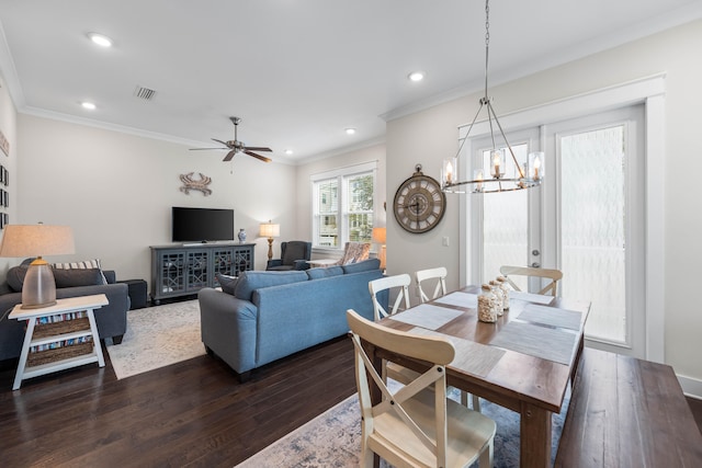 dining room with dark hardwood / wood-style flooring, ceiling fan with notable chandelier, and crown molding