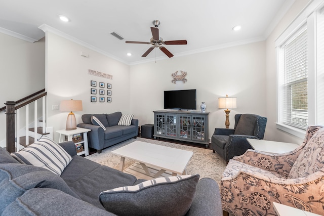 living room featuring crown molding and ceiling fan