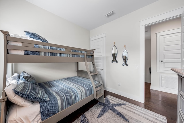 bedroom with dark wood-type flooring