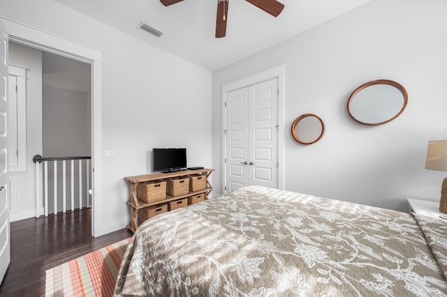 bedroom with a closet, ceiling fan, and dark wood-type flooring