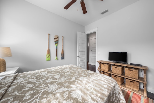 bedroom with dark hardwood / wood-style flooring and ceiling fan