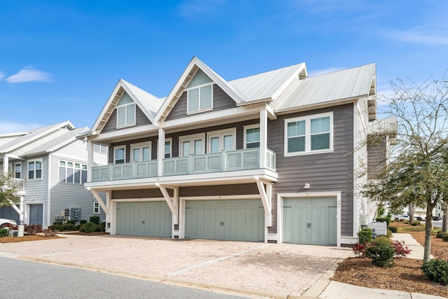 view of property with a garage and a balcony