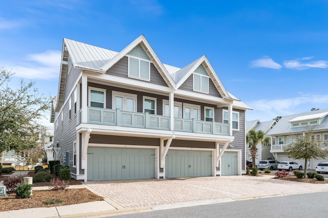 view of front of home with a balcony and a garage