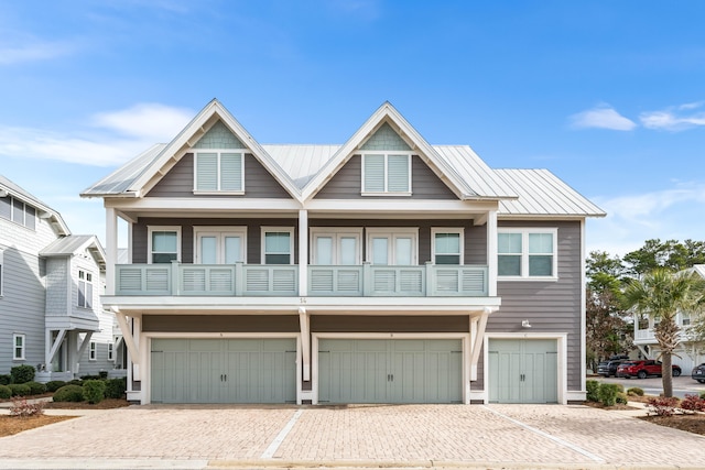 view of front of property with a balcony and a garage