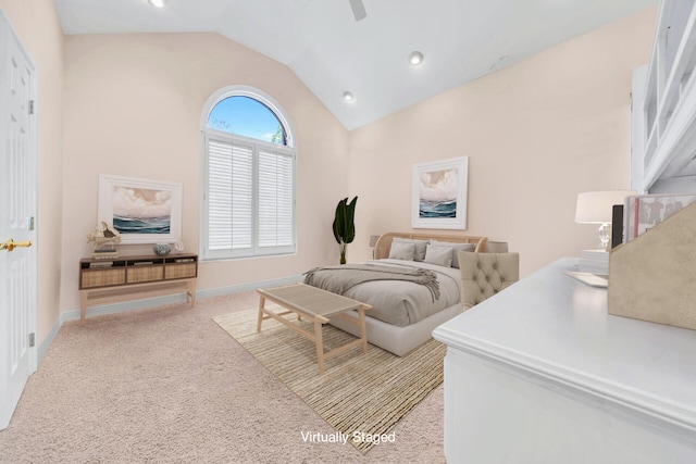 bedroom with ceiling fan, lofted ceiling, and light colored carpet