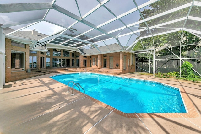 view of swimming pool with a lanai and a patio area